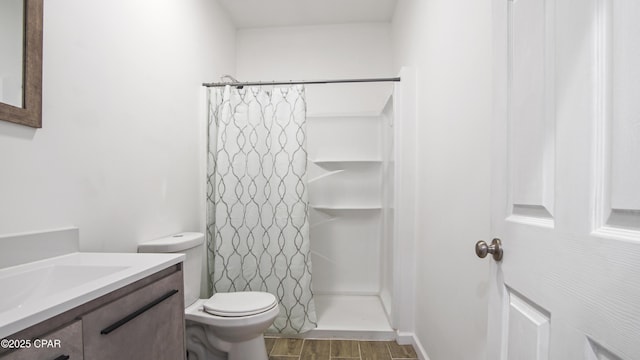 bathroom with toilet, curtained shower, wood finished floors, and vanity