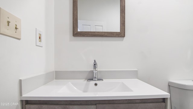 bathroom with toilet and vanity