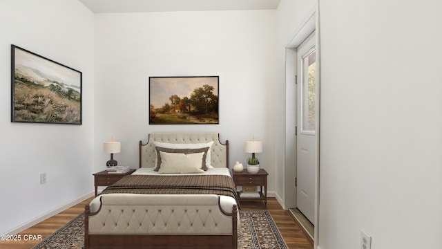 bedroom with baseboards and wood finished floors