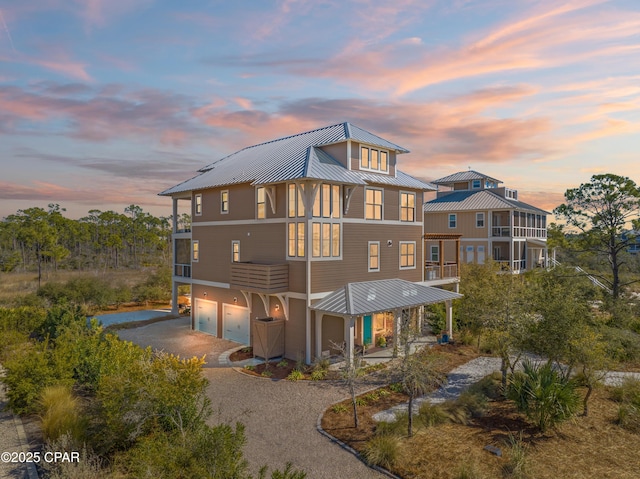 back house at dusk with a garage