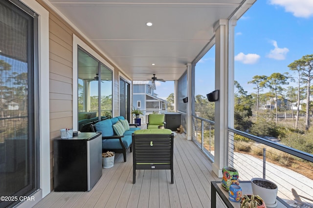 sunroom / solarium featuring ceiling fan