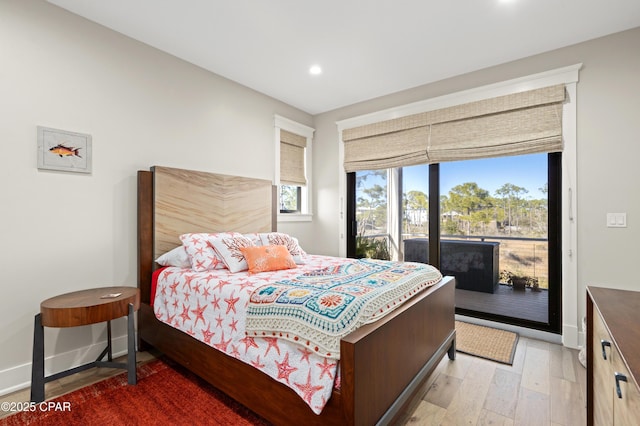 bedroom featuring access to exterior and hardwood / wood-style flooring