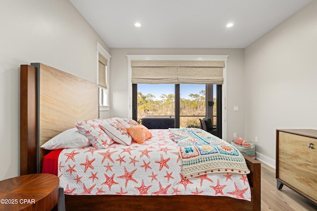 bedroom featuring wood-type flooring and access to outside