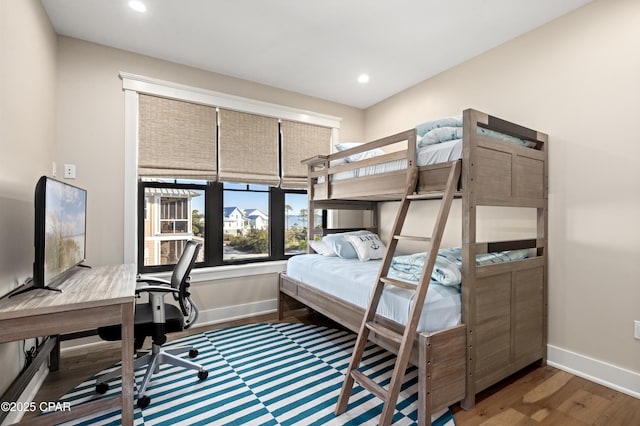 bedroom with dark hardwood / wood-style flooring