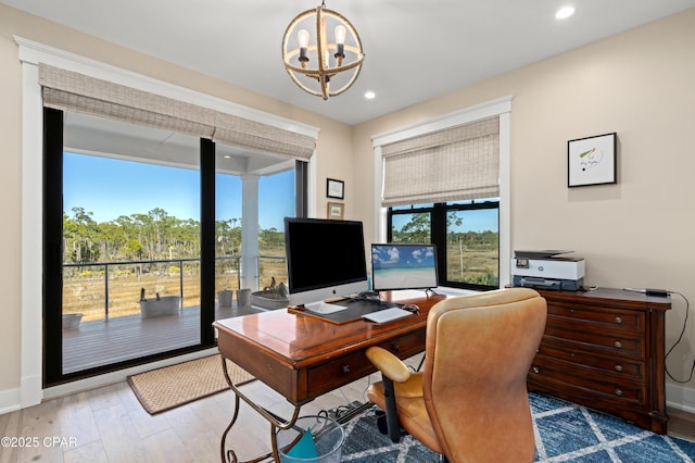 office area featuring wood-type flooring and a chandelier