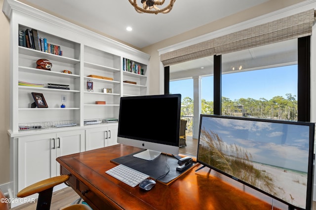 home office with light hardwood / wood-style floors