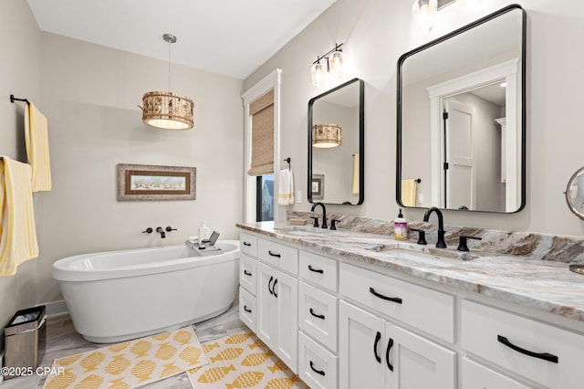 bathroom featuring vanity and a bath