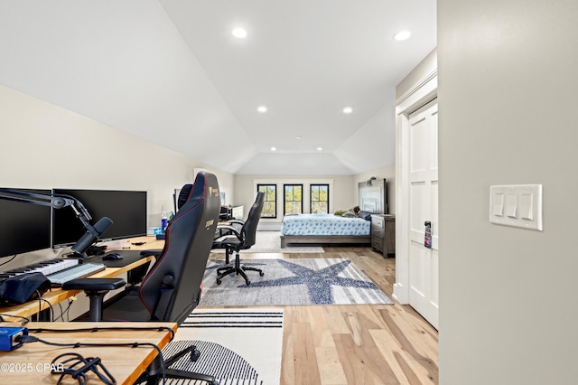 bedroom with lofted ceiling and light wood-type flooring