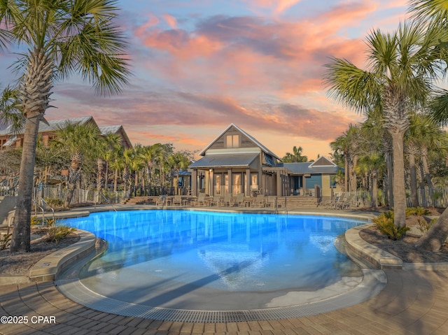 view of pool at dusk