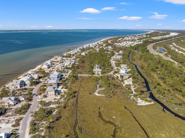 drone / aerial view with a water view and a beach view