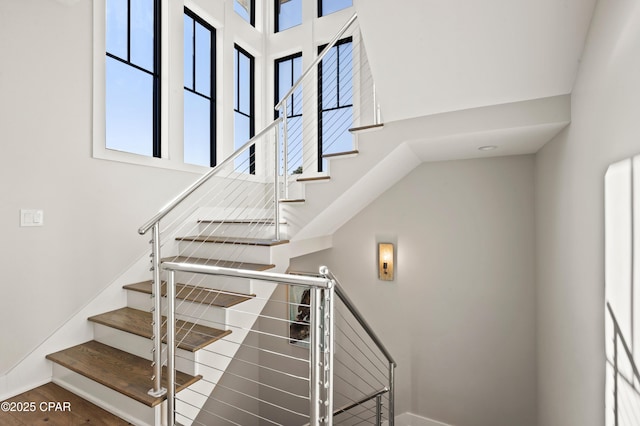 stairs featuring a towering ceiling