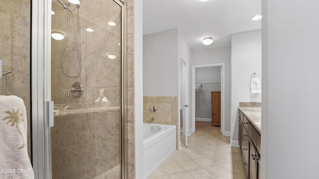 bathroom with vanity, tile patterned floors, and plus walk in shower