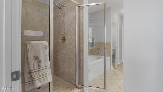 bathroom featuring tile patterned flooring, a bathtub, and toilet