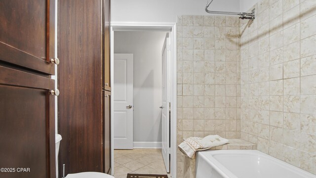 full bathroom with tile patterned flooring, vanity, tiled shower / bath combo, and toilet