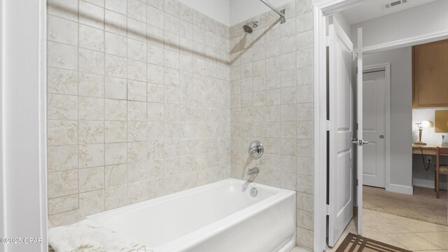 bathroom with shower / bath combination, tile walls, and tile patterned floors