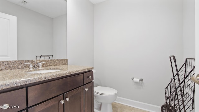 bathroom with vanity, tile patterned floors, and toilet