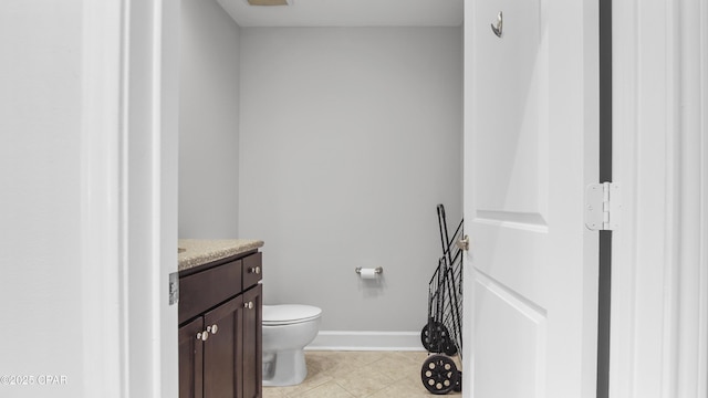 bathroom with vanity, tile patterned floors, and toilet