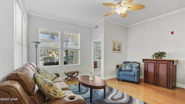 sitting room with ornamental molding, ceiling fan, and light wood-type flooring