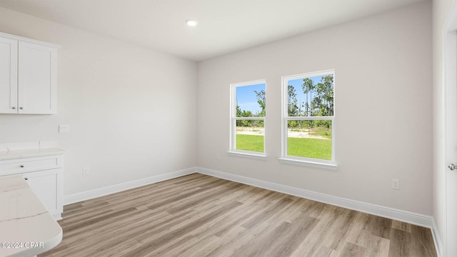 unfurnished dining area with light hardwood / wood-style floors