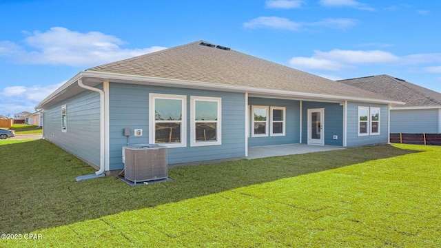 back of house with central AC, a patio, and a lawn