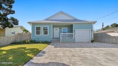 view of front of home featuring a garage, a porch, and a front yard