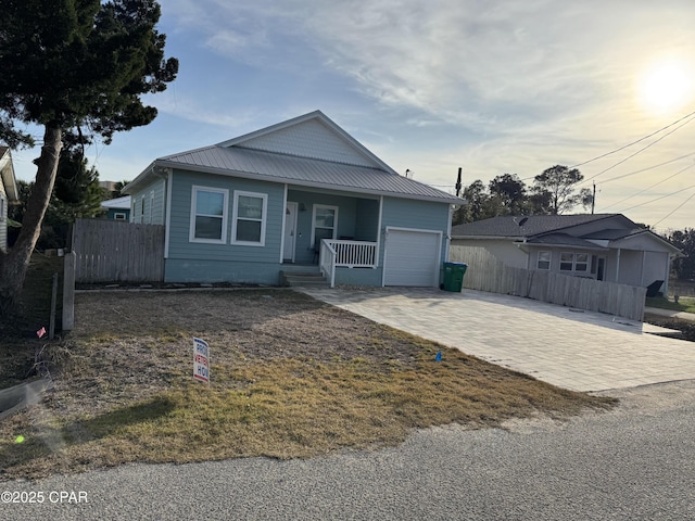 view of front facade featuring a porch and a garage