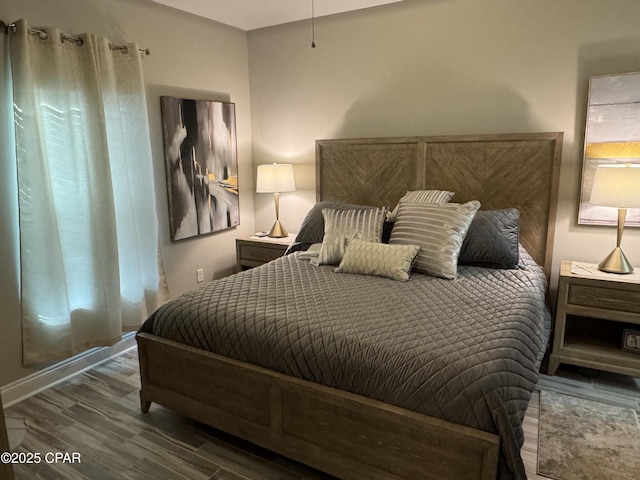 bedroom with dark hardwood / wood-style flooring