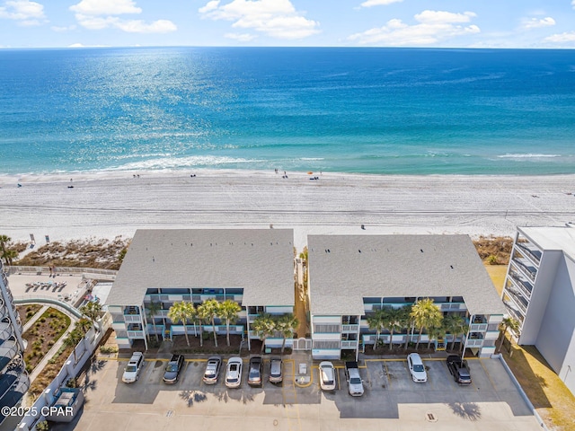 drone / aerial view with a water view and a view of the beach