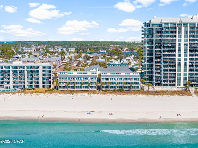 birds eye view of property with a water view and a view of the beach