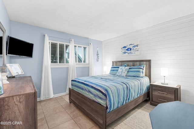 tiled bedroom with a textured ceiling and wood walls