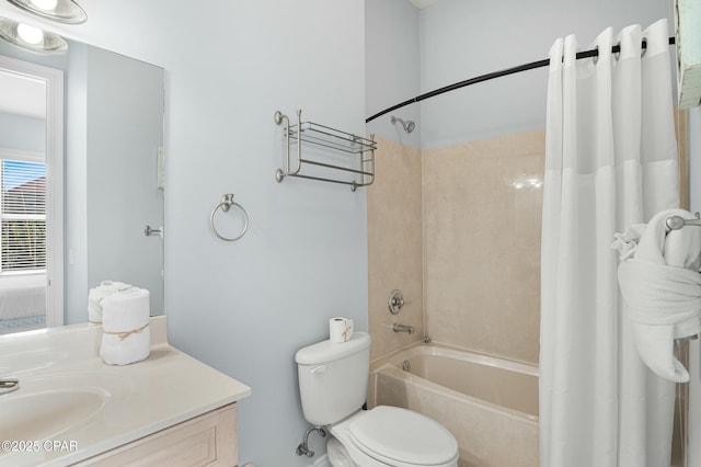 bathroom featuring shower / bath combo, vanity, and toilet