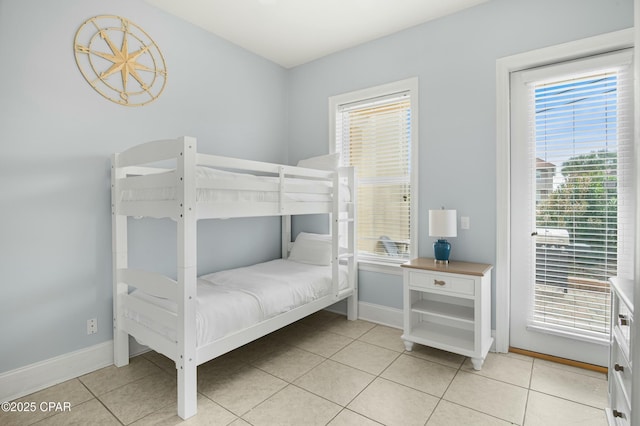 bedroom featuring baseboards and light tile patterned floors