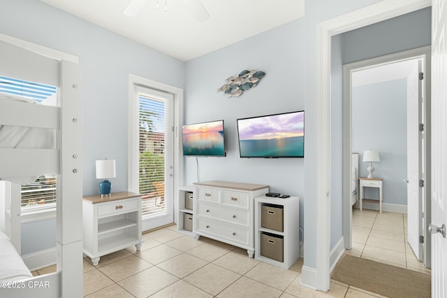 bedroom featuring light tile patterned floors, ceiling fan, baseboards, and access to exterior