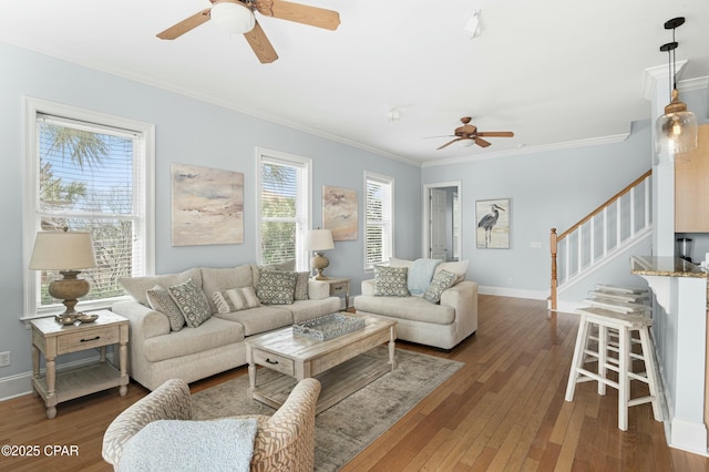 living area with baseboards, stairs, ornamental molding, and dark wood finished floors