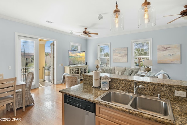 kitchen featuring a sink, ornamental molding, stainless steel dishwasher, and hanging light fixtures