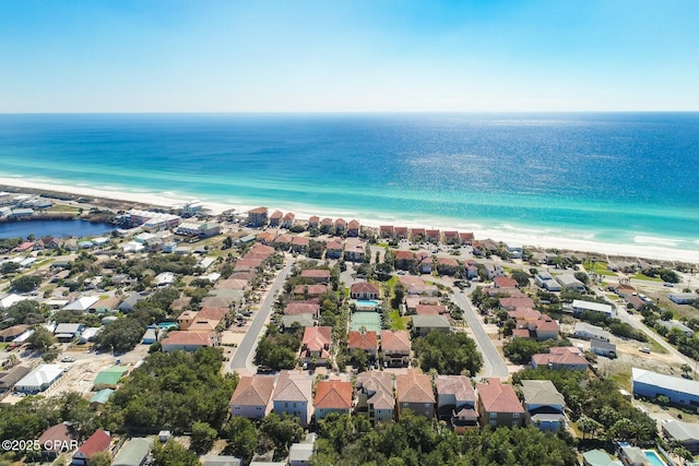 bird's eye view featuring a water view, a view of the beach, and a residential view