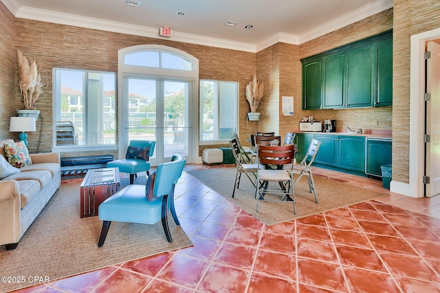 interior space with open floor plan, french doors, tile patterned flooring, and crown molding