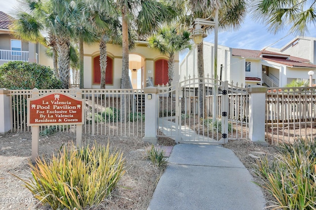 view of home's community featuring a gate and fence