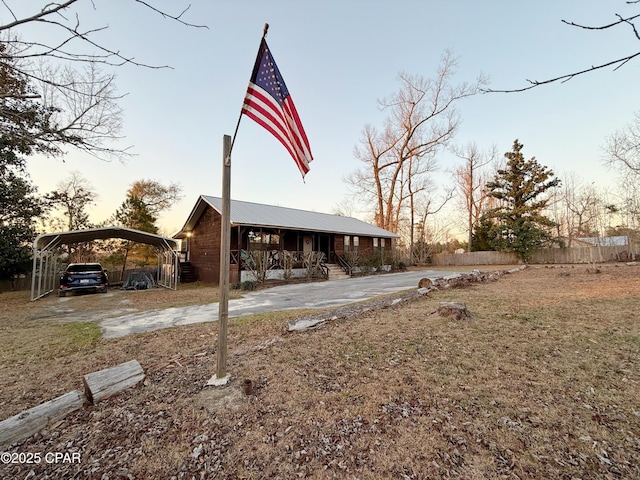 yard at dusk with a carport and covered porch