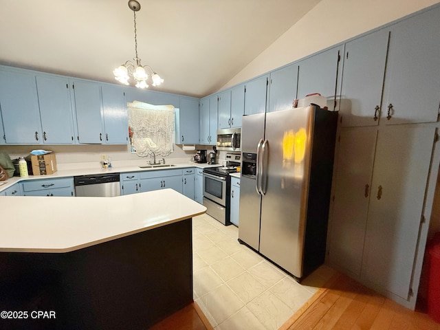 kitchen with a sink, lofted ceiling, blue cabinetry, and stainless steel appliances