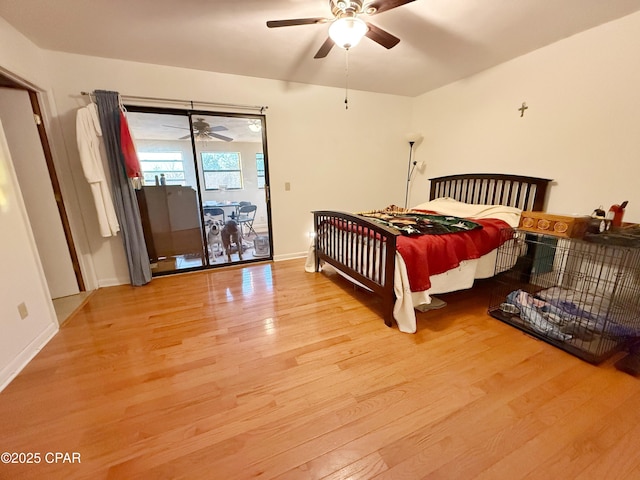 bedroom featuring ceiling fan, baseboards, wood finished floors, and access to exterior