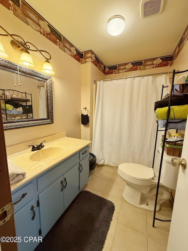 full bathroom with visible vents, toilet, curtained shower, tile patterned flooring, and vanity