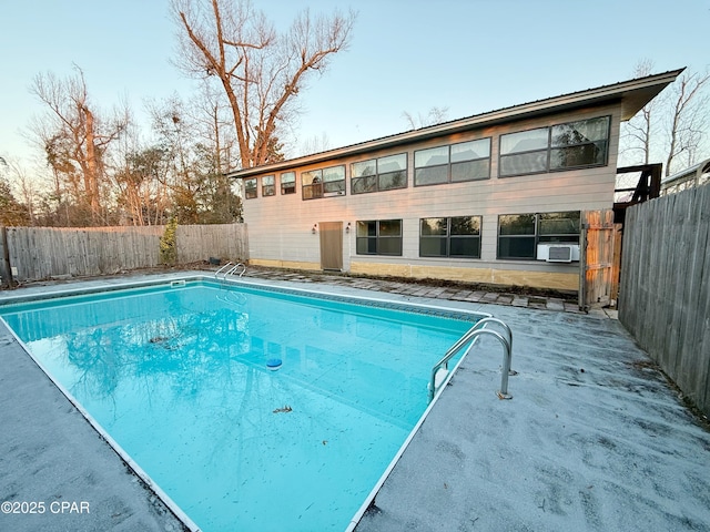 view of swimming pool with a fenced in pool, cooling unit, and a fenced backyard