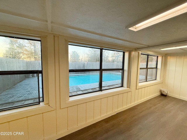 unfurnished sunroom with plenty of natural light