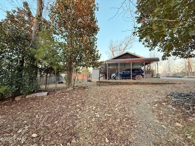 view of yard featuring a carport and fence