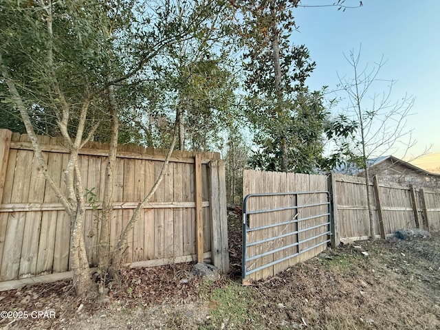 view of gate featuring fence