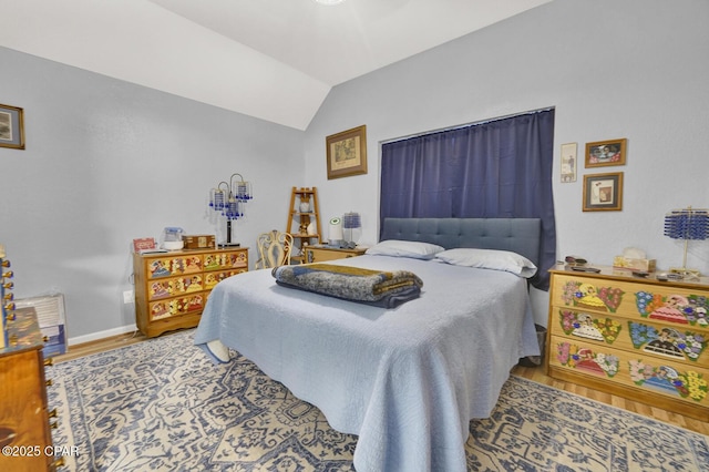 bedroom with lofted ceiling and hardwood / wood-style flooring