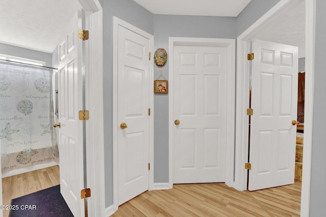 hallway featuring light hardwood / wood-style flooring