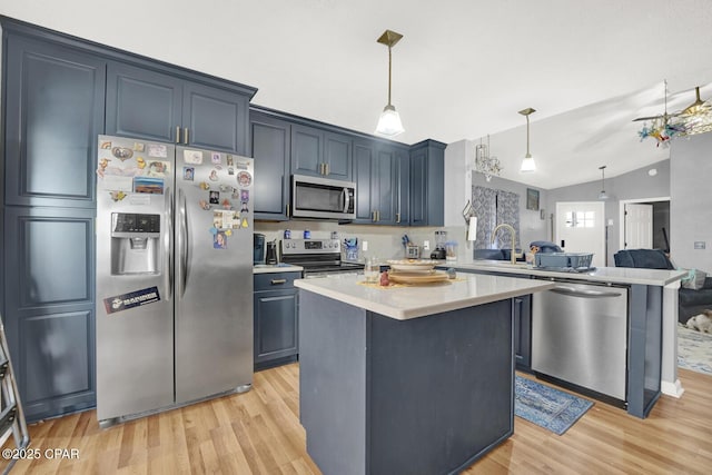 kitchen featuring pendant lighting, a center island, kitchen peninsula, and appliances with stainless steel finishes