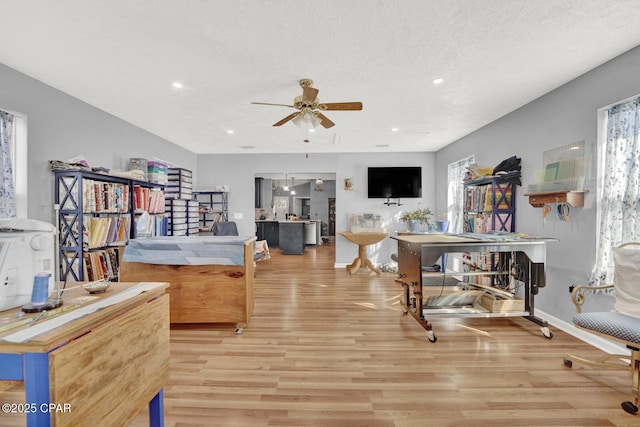 bedroom with a textured ceiling and light hardwood / wood-style floors